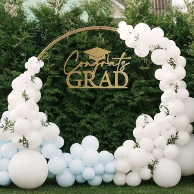Round backdrop with balloons for graduation party.